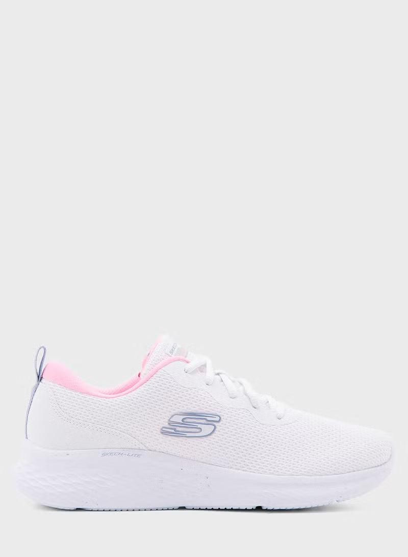 White sneaker with pink accents on a white background