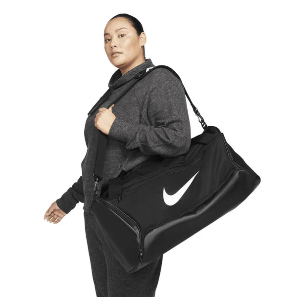 Black Nike duffel bag with white logo on a white background